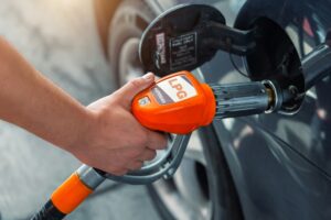 fuel autogas pump gun connected with noozle adapter car tank to refill at car gas filling station.